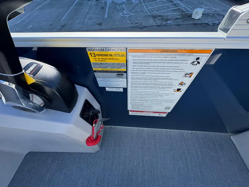 Slide: The Image of Control panel and safety warnings on 2025 Xperience 2286 SBX boat. - 14