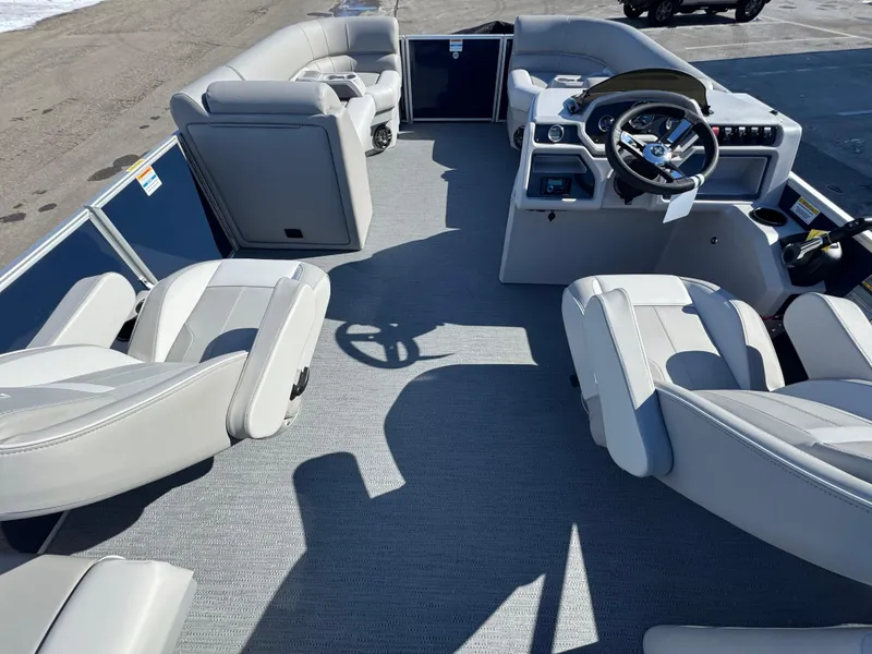 Slide: The Image of 2025 Xperience 2286 SBX pontoon boat interior with modern seating and steering console. - 5