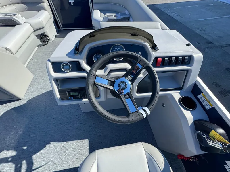 Slide: The Image of 2025 Xperience 2286 SBX boat interior with steering wheel and control panel. - 6