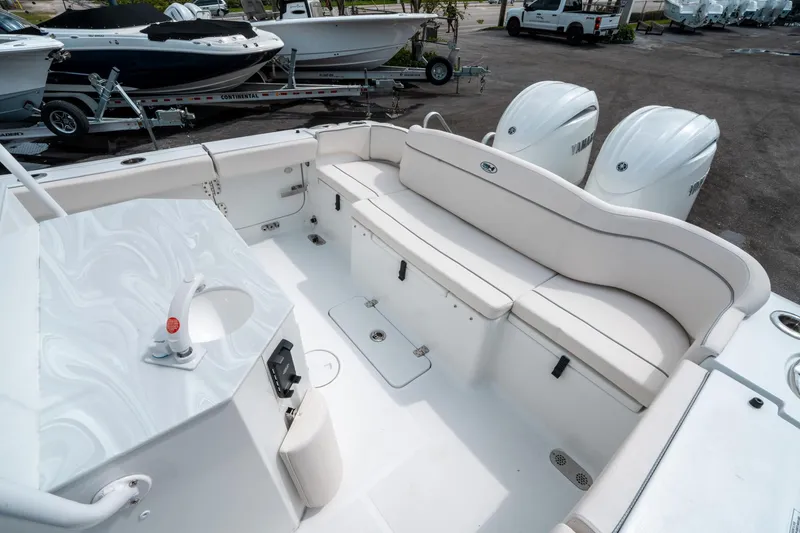 Slide: The Image of 2025 Sea Hunt Ultra 275 SE boat interior with seating and dual Yamaha engines. - 11