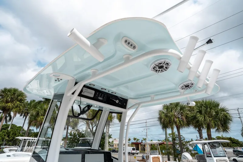 Slide: The Image of Sea Hunt Ultra 275 SE 2025 boat with rod holders and speakers, set against a tropical backdrop. - 22