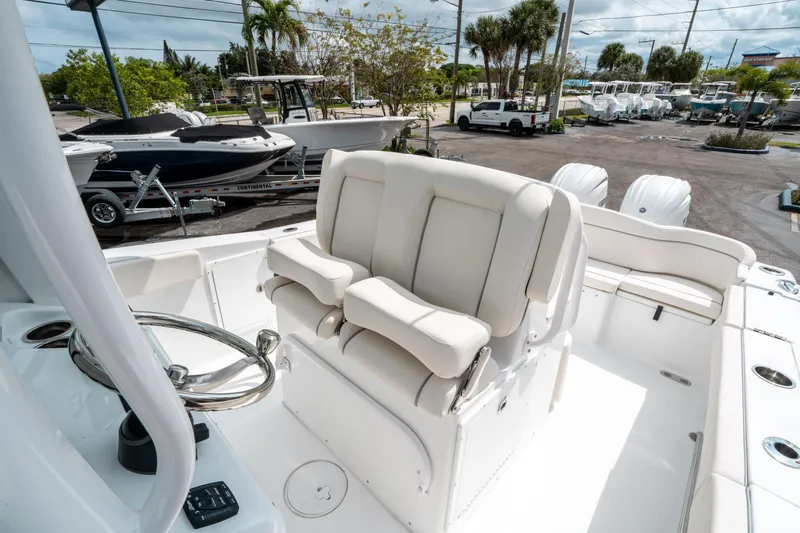 Slide: The Image of 2025 Sea Hunt Ultra 275 SE boat interior with plush seating and steering wheel. - 26