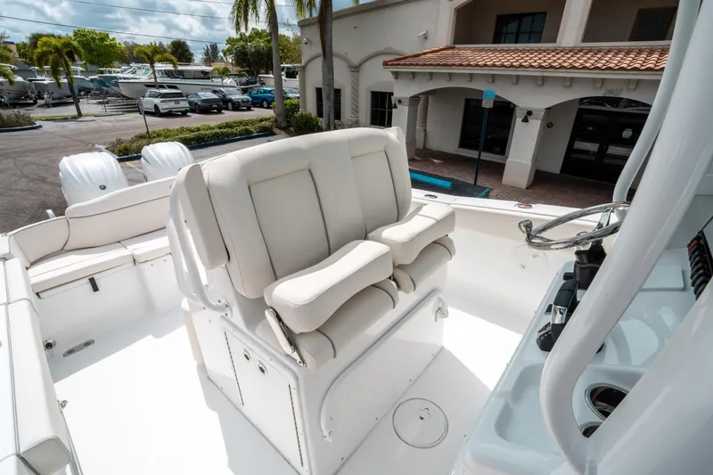 Slide: The Image of 2025 Sea Hunt Ultra 275 SE boat interior with plush seating and steering console. - 27