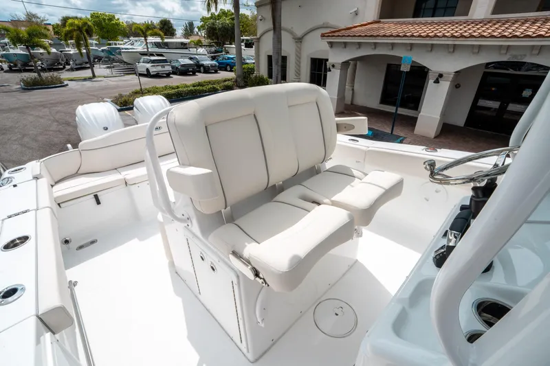 Slide: The Image of 2025 Sea Hunt Ultra 275 SE boat interior with white seating and steering wheel. - 28