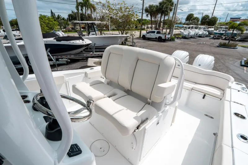 Slide: The Image of 2025 Sea Hunt Ultra 275 SE boat interior with white seating and steering wheel. - 29