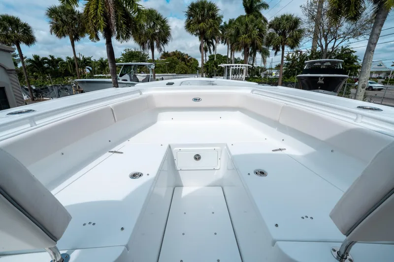 Slide: The Image of 2025 Sea Hunt Ultra 275 SE boat interior with spacious seating and palm trees in the background. - 36