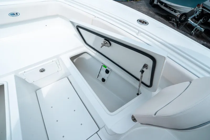 Slide: The Image of 2025 Sea Hunt Ultra 275 SE boat storage compartment open, showcasing interior features. - 39