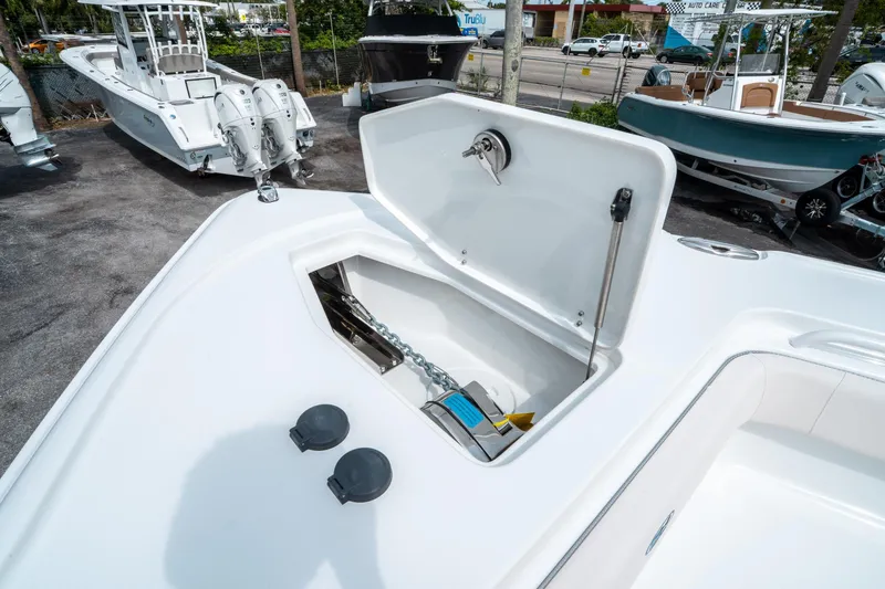 Slide: The Image of 2025 Sea Hunt Ultra 275 SE boat anchor compartment, open lid, outdoor display. - 42