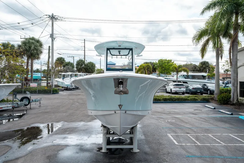 Slide: The Image of 2025 Sea Hunt Ultra 275 SE boat displayed in a parking lot with palm trees. - 7
