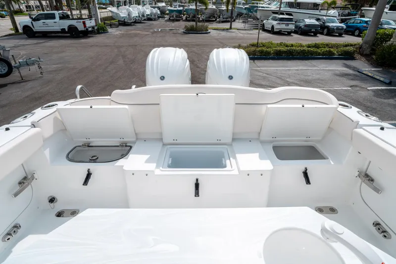 Slide: The Image of 2025 Sea Hunt Ultra 275 SE boat deck with storage compartments and dual engines. - 14