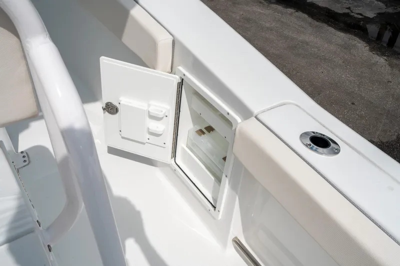 Slide: The Image of 2025 Sea Hunt Ultra 275 SE boat storage compartment with open hatch. - 18