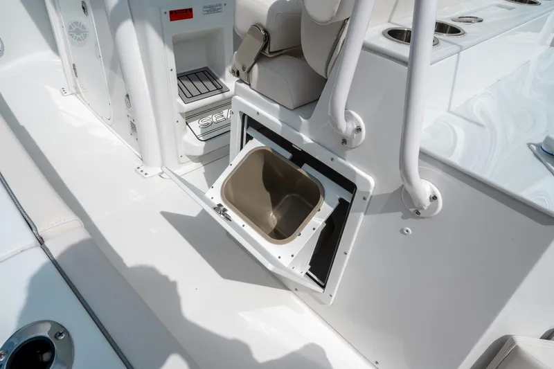 Slide: The Image of 2025 Sea Hunt Ultra 275 SE boat interior with open storage compartment. - 19