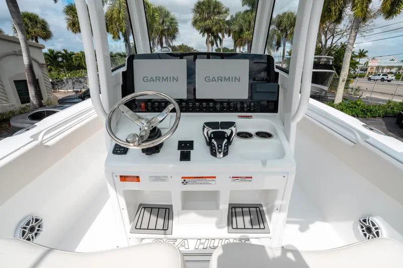 Slide: The Image of 2025 Sea Hunt Ultra 275 SE boat dashboard with Garmin displays and steering wheel. - 23