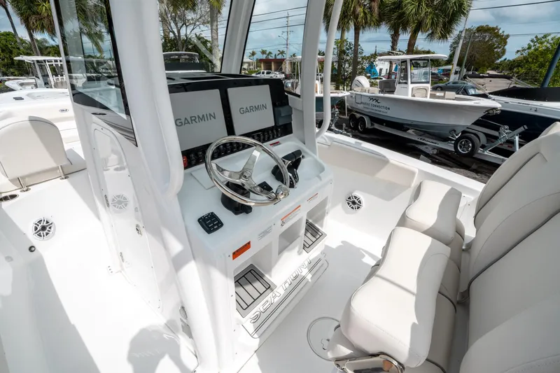 Slide: The Image of 2025 Sea Hunt Ultra 275 SE boat cockpit with Garmin displays and plush seating. - 25