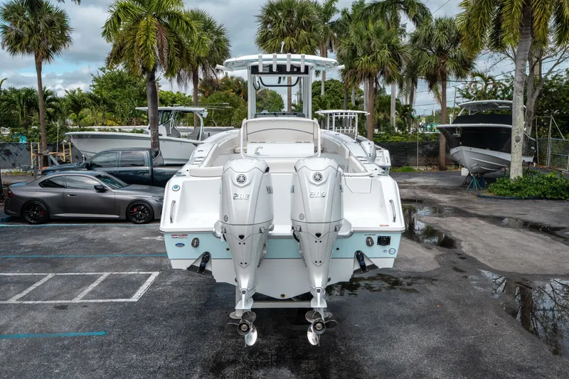 Slide: The Image of 2025 Sea Hunt Ultra 275 SE boat with dual engines, parked outdoors. - 3