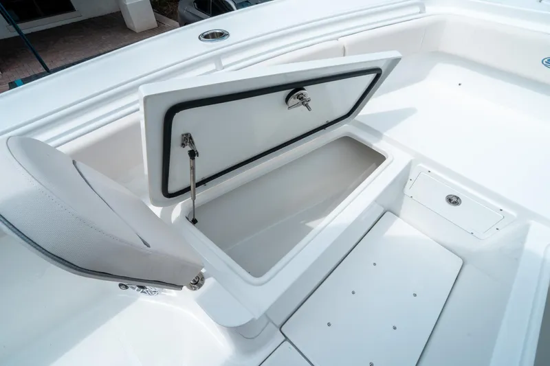 Slide: The Image of 2025 Sea Hunt Ultra 275 SE boat storage compartment with open lid and seating. - 38