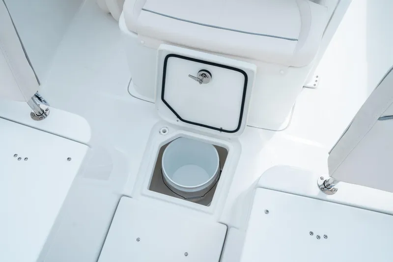 Slide: The Image of 2025 Sea Hunt Ultra 275 SE boat interior with storage compartment and bucket. - 40