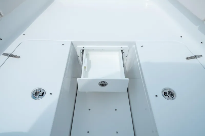 Slide: The Image of 2025 Sea Hunt Ultra 275 SE boat storage compartment with open hatch. - 41
