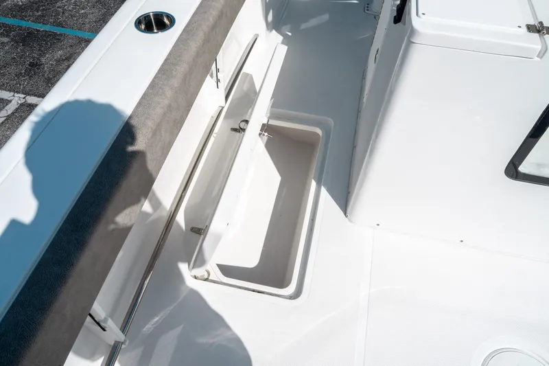 Slide: The Image of 2025 Sea Hunt Gamefish 30 CB boat interior with open storage compartment. - 17