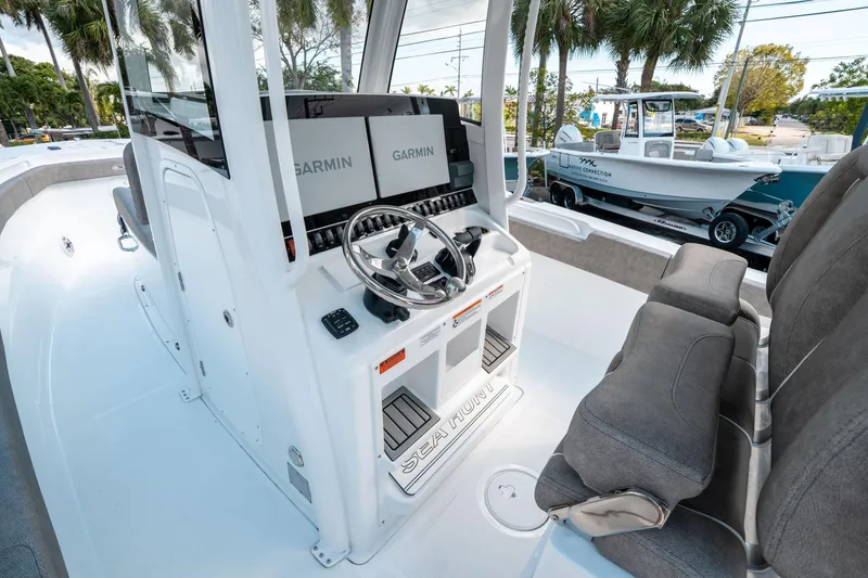 Slide: The Image of 2025 Sea Hunt Gamefish 30 CB boat interior with Garmin displays and plush seating. - 28