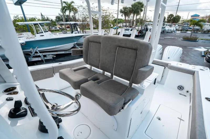 Slide: The Image of 2025 Sea Hunt Gamefish 30 CB boat interior with dual seats and steering wheel. - 32