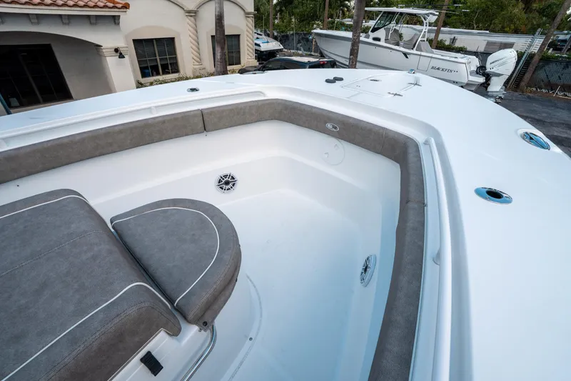 Slide: The Image of 2025 Sea Hunt Gamefish 30 CB boat interior with cushioned seating and sleek design. - 36