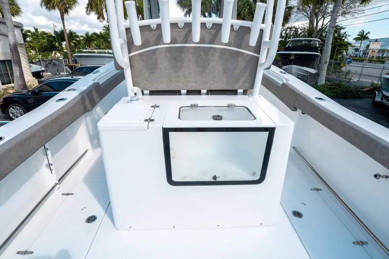 Slide: The Image of 2025 Sea Hunt Gamefish 30 CB boat interior with livewell and rod holders. - 16