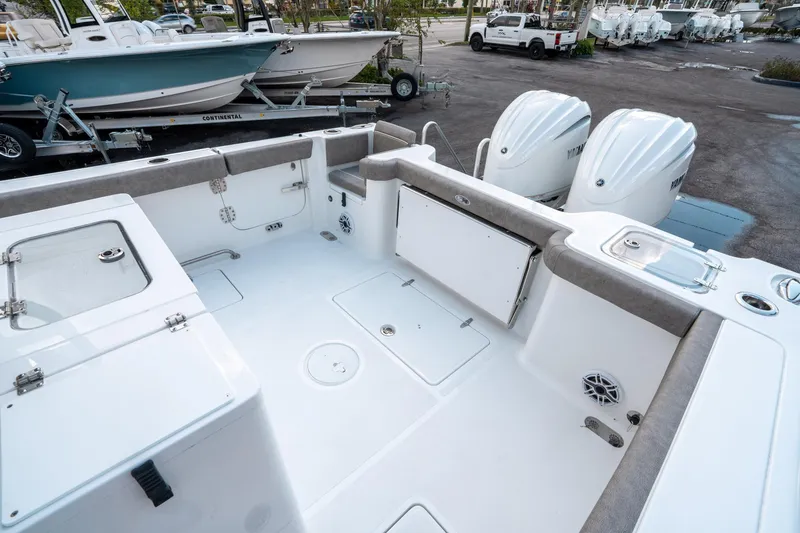 Slide: The Image of 2025 Sea Hunt Gamefish 30 CB boat interior with dual engines and spacious deck. - 11