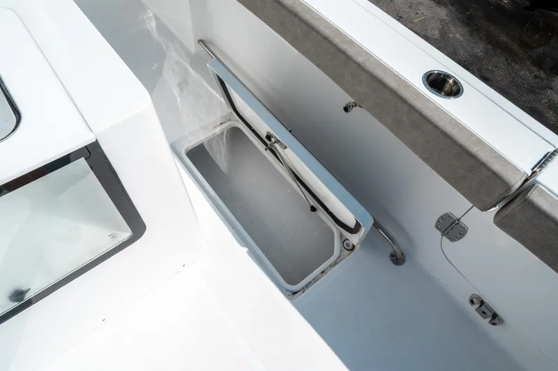 Slide: The Image of 2025 Sea Hunt Gamefish 30 CB boat storage compartment with open lid. - 18