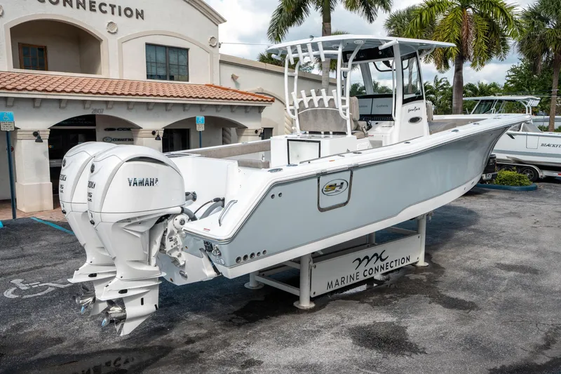 Slide: The Image of 2025 Sea Hunt Gamefish 30 CB boat with twin Yamaha engines at Marine Connection dealership. - 2