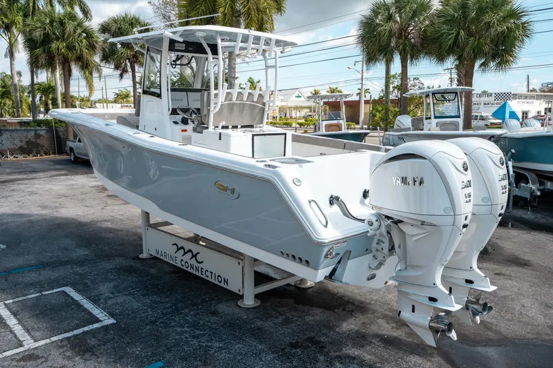 Slide: The Image of 2025 Sea Hunt Gamefish 30 CB boat with twin Yamaha engines, displayed outdoors. - 4