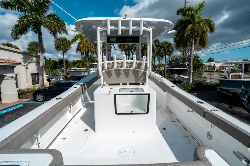 Slide: The Image of 2025 Sea Hunt Gamefish 30 CB boat, spacious deck, palm trees in background. - 9