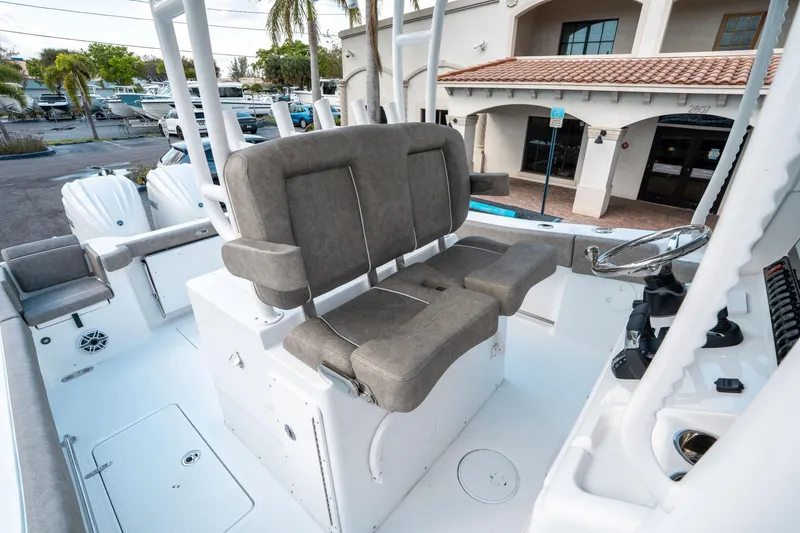 Slide: The Image of 2025 Sea Hunt Gamefish 30 CB boat interior with dual helm seats and steering console. - 31