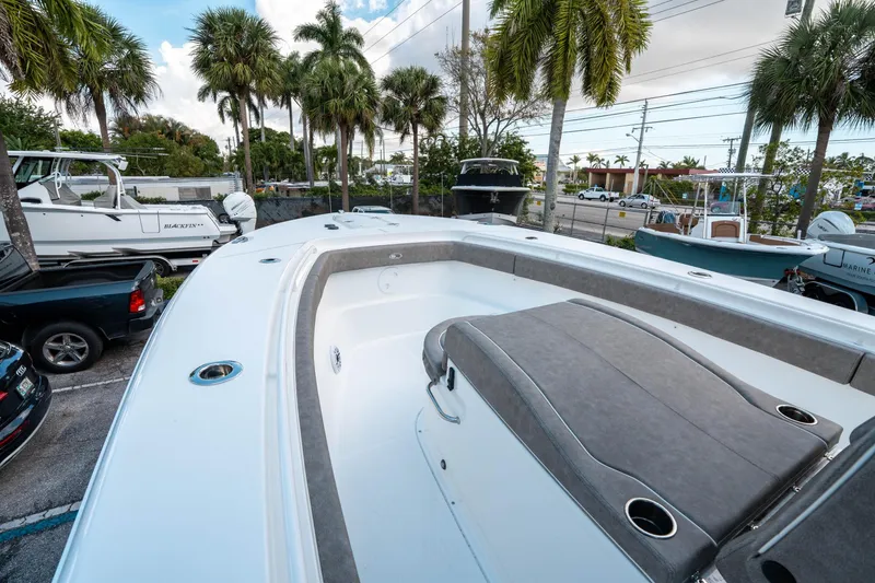 Slide: The Image of 2025 Sea Hunt Gamefish 30 CB boat, spacious deck, palm trees in background. - 34