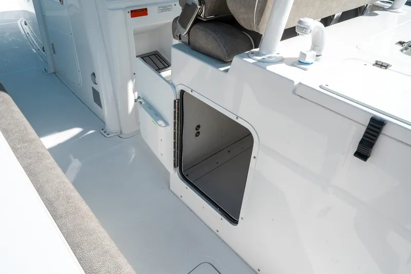 Slide: The Image of 2025 Sea Hunt Gamefish 30 CB boat interior with open storage compartment. - 24