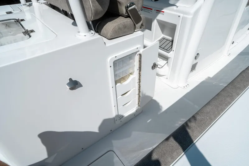 Slide: The Image of 2025 Sea Hunt Gamefish 30 CB boat interior with open storage compartment. - 25