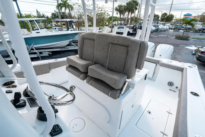 Slide: The Image of 2025 Sea Hunt Gamefish 30 CB boat interior with helm seating and controls. - 29