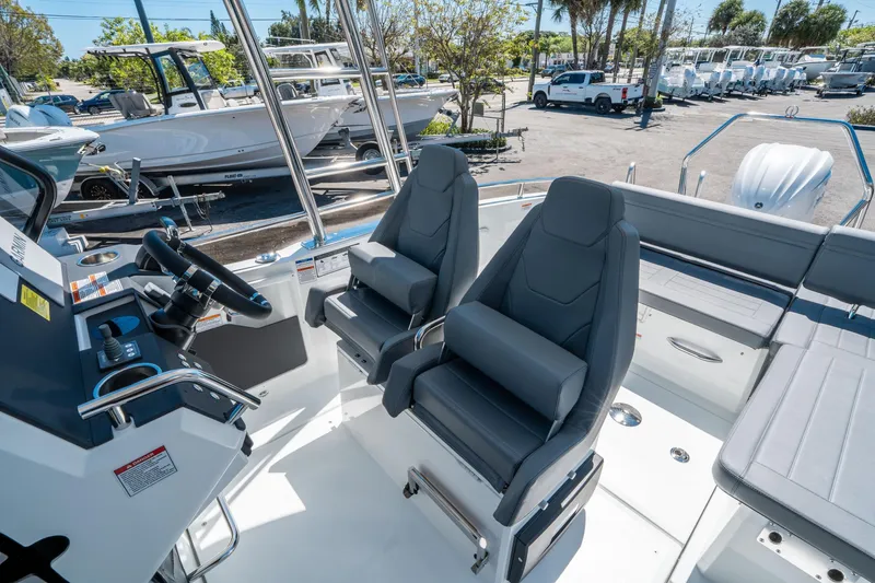 Slide: The Image of 2025 Quarken 27 T-Top boat interior with modern seating and steering console. - 15