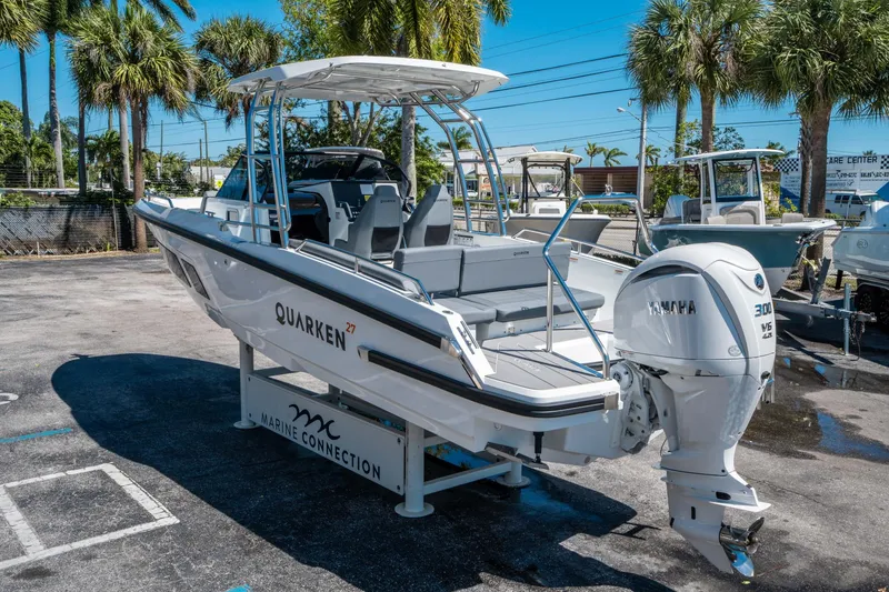 Slide: The Image of 2025 Quarken 27 T-Top boat with Yamaha engine, displayed outdoors under palm trees. - 4