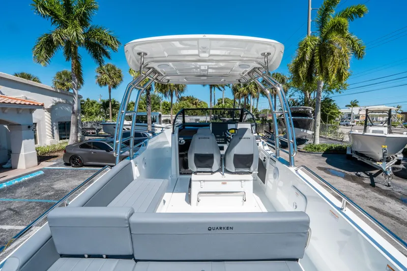 Slide: The Image of 2025 Quarken 27 T-Top boat with sleek design, parked under palm trees. - 9
