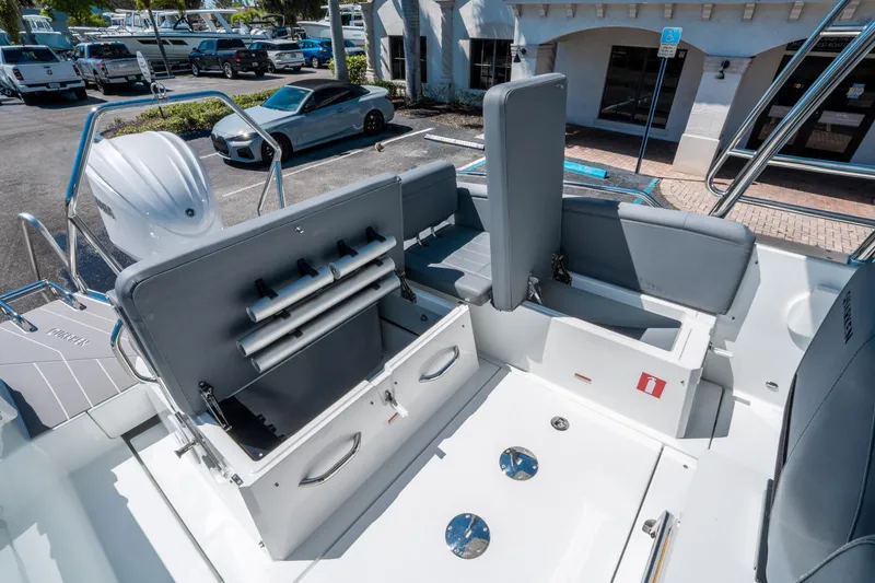 Slide: The Image of 2025 Quarken 27 T-Top boat interior with open storage compartments and seating. - 11