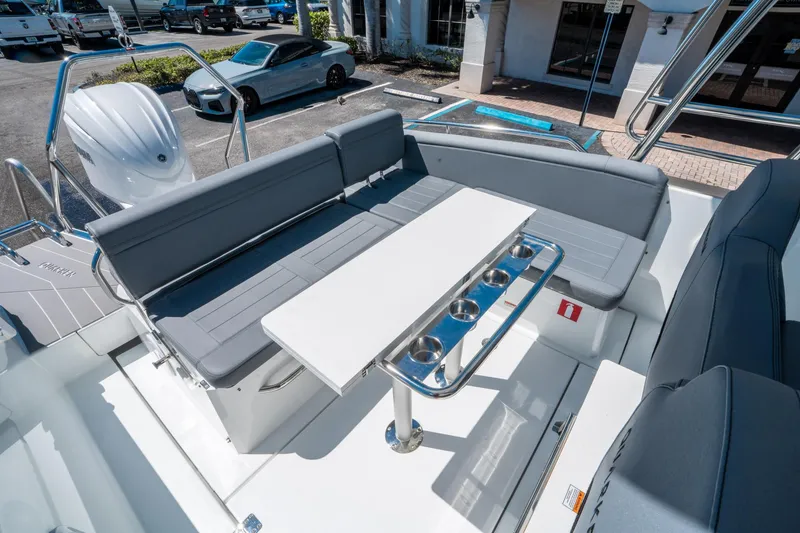 Slide: The Image of 2025 Quarken 27 T-Top boat interior with seating and table, showcasing modern design. - 12