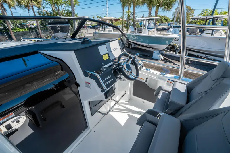 Slide: The Image of Interior of 2025 Quarken 27 T-Top boat with modern steering and seating. - 14