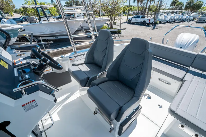 Slide: The Image of 2025 Quarken 27 T-Top boat interior with dual seats and steering console. - 16