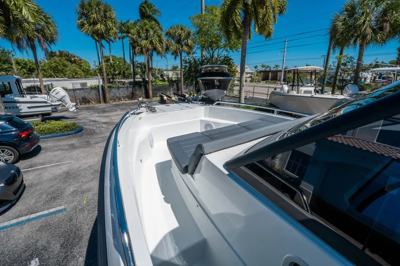 Slide: The Image of 2025 Quarken 27 T-Top boat in a sunny marina setting with palm trees. - 17
