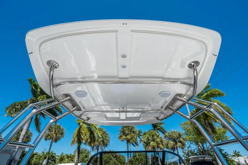 Slide: The Image of 2025 Quarken 27 T-Top boat with stainless steel frame against blue sky and palm trees. - 22