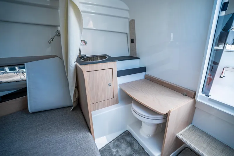 Slide: The Image of Interior of 2025 Quarken 27 T-Top boat with compact sink and toilet. - 26