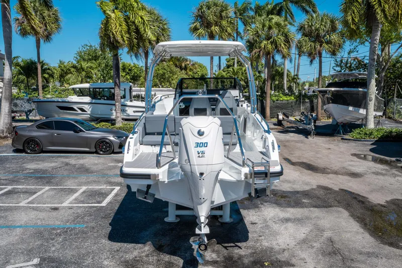 Slide: The Image of 2025 Quarken 27 T-Top boat with powerful engine, parked outdoors near palm trees. - 3