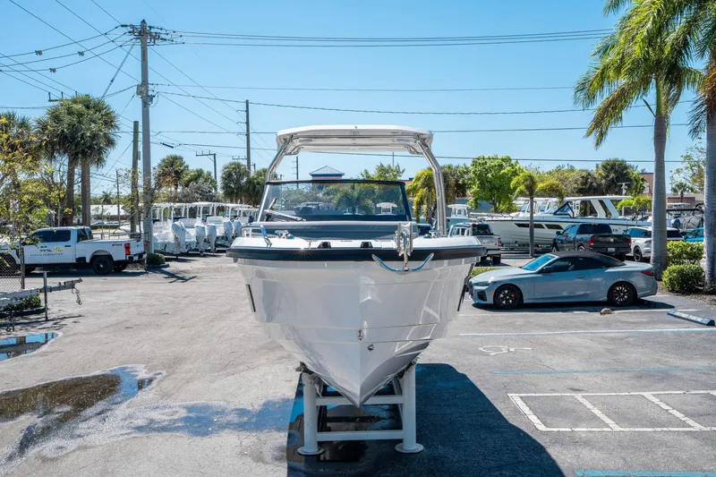 Slide: The Image of 2025 Quarken 27 T-Top boat displayed outdoors in a parking lot. - 7