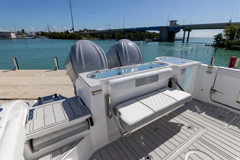 Slide: The Image of 2025 Sea Fox 328 Commander boat with dual engines, docked by a scenic waterfront. - 11